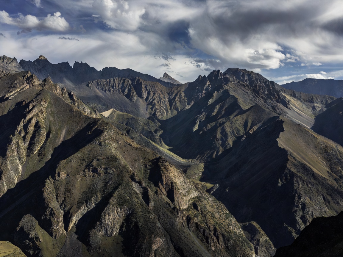Dramatic mountain ridges in Central Asia surrounding the Fergana Valley
